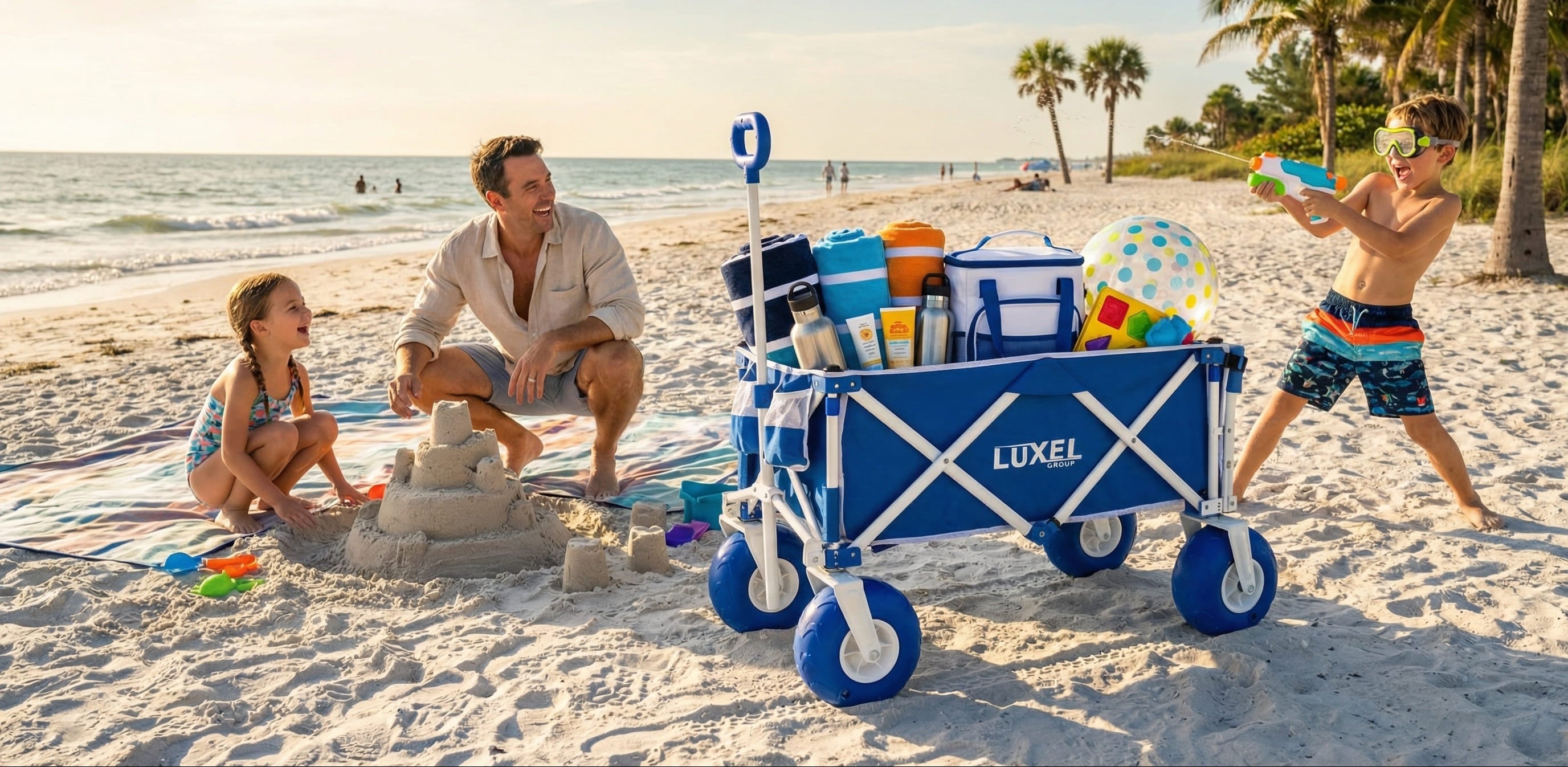 Family on a beach with a Luxel beach cart filled with toys