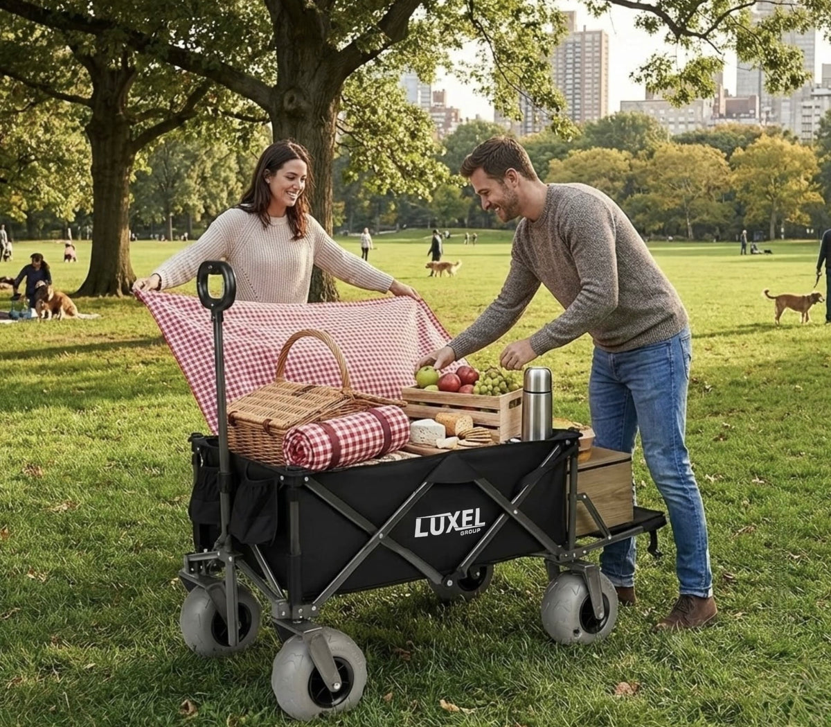 Man and woman with a picnic setup on a LUXEL wagon in a park.