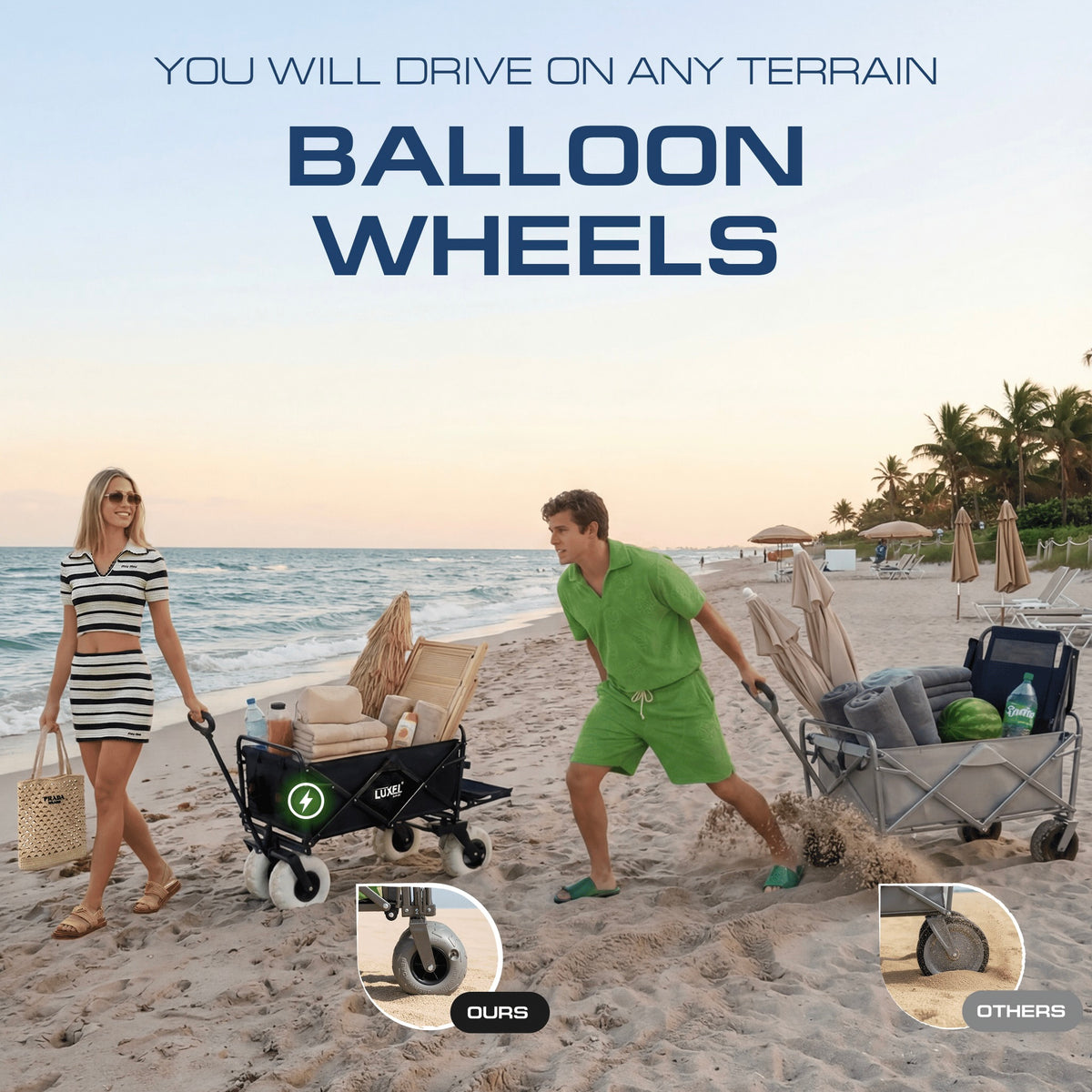 Two people pushing beach wagons with balloon wheels on a sandy beach.