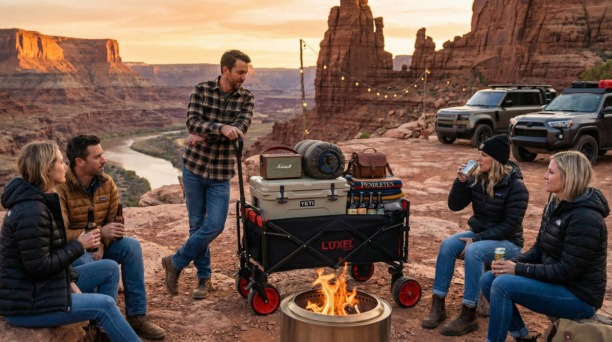 Group of people around a campfire with camping gear and vehicles in a desert landscape.