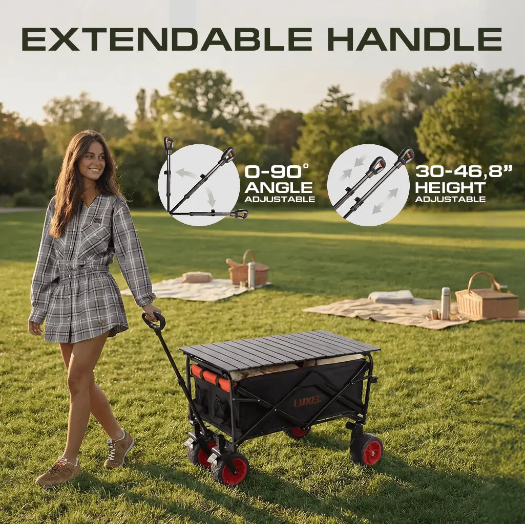 Woman pushing a foldable wagon with extendable handle feature in a park setting.